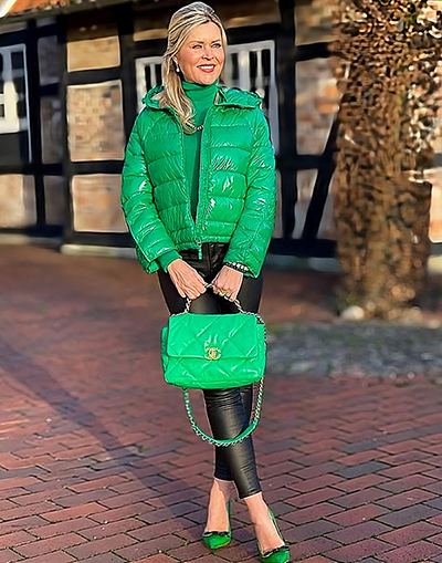 Green outerwear and accessories with black pants