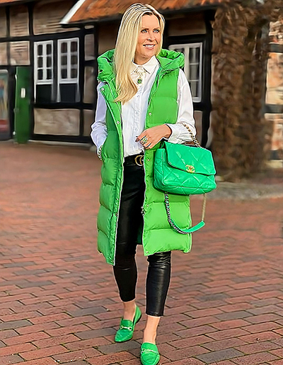 Green outerwear, white shirt, and black pants