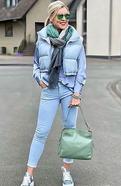 Light blue down vest with a voluminous collar for a slimming effect