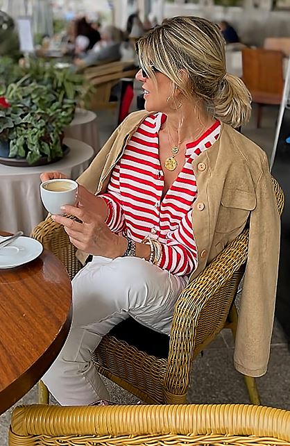 Beige suede jacket draped over shoulders for a sophisticated look