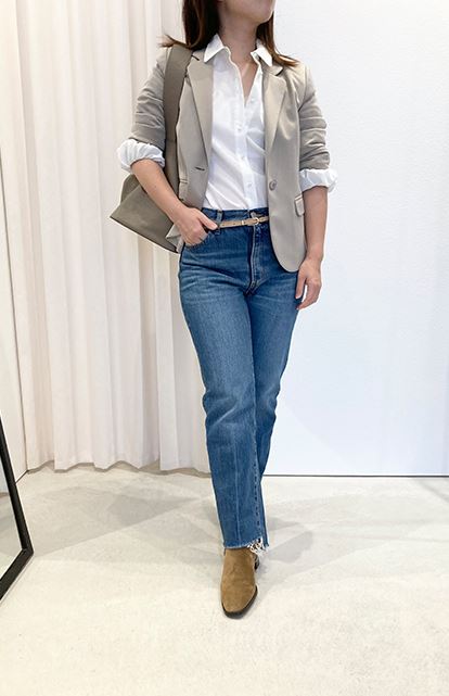 Rolled-up jacket sleeves with a white shirt and denim jeans