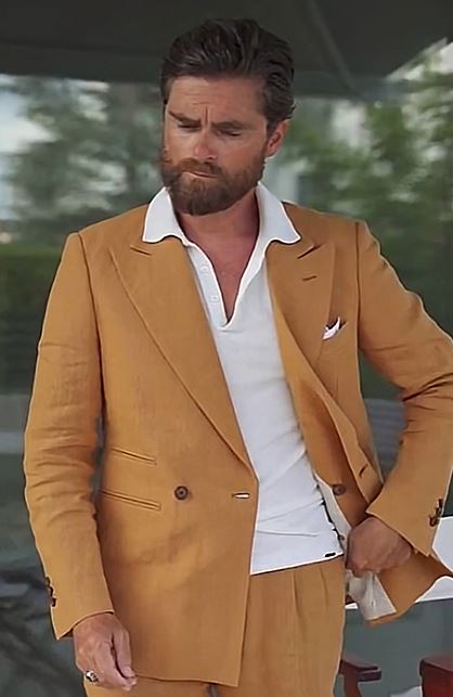 Orange suit with white polo shirt styled elegantly