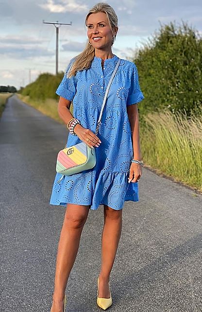 Beige pumps with a vibrant blue dress