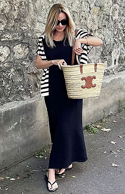 Maxi dress with a striped cardigan and a straw bag